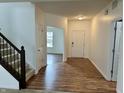 Inviting foyer with hardwood floors, staircase, and front door access to the bright interior of the home at 837 Sommersweet Run, Greenwood, IN 46143