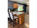Modern kitchen with quartz countertops, stainless steel refrigerator and eat in island at 8410 Woodlawn Dr, Martinsville, IN 46151