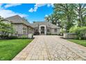 Beautiful brick home showcasing a well-manicured lawn and a paved circular driveway at 8905 Stonebriar Dr, Indianapolis, IN 46259
