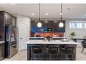 Modern kitchen boasts a center island, stainless steel appliances, and sleek cabinetry at 9234 Anthem Ave, Plainfield, IN 46168