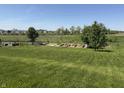 View of the backyard with green grass, trees and a garden at 928 Cherry Tree Ln, Greenwood, IN 46143