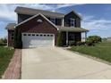 Two-story home with brick and siding, featuring an attached two-car garage and well-maintained front lawn at 928 Cherry Tree Ln, Greenwood, IN 46143