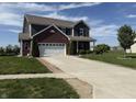 Two-story home with brick and siding, featuring an attached two-car garage and well-maintained front lawn at 928 Cherry Tree Ln, Greenwood, IN 46143
