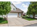 Lovely townhome featuring an attached garage, a wide driveway and mature trees at 9404 Enclave Dr # D, Avon, IN 46123