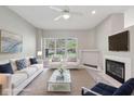 Comfortable living room featuring a fireplace, plush seating, and abundant natural light at 9760 Innisbrook Blvd, Carmel, IN 46032
