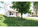 Well-maintained two-story home with a lush green lawn and a charming front porch at 10773 Brighton Knoll S Pkwy, Noblesville, IN 46060