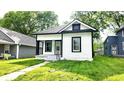 Charming bungalow with black and white trim, featuring a small front porch and walkway to the home at 1148 N Pershing Ave, Indianapolis, IN 46222