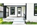 Close up of porch with view of front door, black and white trim, and dark pillars at 1148 N Pershing Ave, Indianapolis, IN 46222