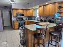 Well-lit kitchen features ample cabinet space, modern appliances, and a breakfast bar at 1214 Lindsey Ln, Lebanon, IN 46052