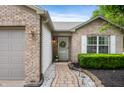 Close up of brick home showcasing a welcoming entryway with decorative wreath at 12446 Deerview Dr, Noblesville, IN 46060
