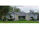 Charming single-story home featuring stone accents, gray siding, well-manicured lawn and covered porch at 12681 E 79Th St, Indianapolis, IN 46236
