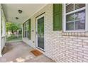 The front porch features a brick facade, green shutters, and a welcoming entrance mat at 13063 E 131St St, Fishers, IN 46037
