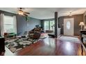 The open-concept living room features hardwood floors, natural light, and a cozy atmosphere at 13295 Patriotic Way, Fishers, IN 46037