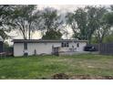 Backyard view with a patio, lawn, and wooden fence offering a private outdoor space for relaxation at 1505 Apple St, Greenfield, IN 46140