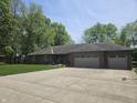 Charming brick home with a well-manicured lawn, updated garage doors, and paved driveway at 1515 Renee Dr, Plainfield, IN 46168