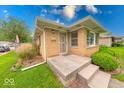 Inviting home with a tidy, stepped front porch and low-maintenance landscaping at 2150 Main St, Beech Grove, IN 46107