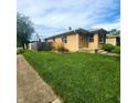 Lovely brick home featuring a beautiful lawn and established landscaping at 2150 Main St, Beech Grove, IN 46107