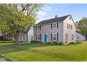 Traditional two-story home on a well-maintained lawn, surrounded by mature trees in a suburban neighborhood at 2336 Sycamore St, Columbus, IN 47201