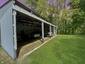 Open barn with a vehicle, trailer, and lawnmower at 2548 N Letterman Rd, Paragon, IN 46166