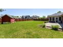 Large backyard with a wooden deck, a storage shed and mature trees at 3126 Oakmont Dr, Lapel, IN 46051