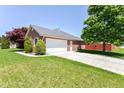 A beautiful garage-side home exterior with a pristine lawn and attractive landscaping at 3126 Oakmont Dr, Lapel, IN 46051