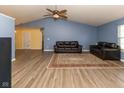 Open living space with hardwood floors, vaulted ceilings, comfortable seating, and an inviting atmosphere at 320 Red Tail Ln, Indianapolis, IN 46241
