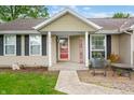 Charming home entrance with a walkway, seating area and 'welcome home' sign at 3334 Old Field Ln, Columbus, IN 47203