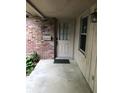 The front porch features a classic door, brick wall, and a lantern, offering a warm welcome at 3619 31St St, Columbus, IN 47203