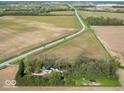 Aerial view of property showcasing its expansive land and proximity to fields at 3868 E Worthsville Rd, Whiteland, IN 46184