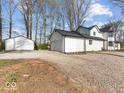 View of home with detached garage and well-maintained yard at 3868 E Worthsville Rd, Whiteland, IN 46184