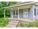 Front porch of a charming home, with classic columns and a welcoming entrance at 42 E Brookville Rd, Fountaintown, IN 46130