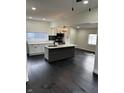 Open-concept kitchen with an island, stainless steel appliances, and modern lighting fixtures at 44 S Butler Ave, Indianapolis, IN 46219
