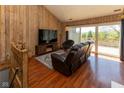 Comfortable living room with hardwood floors and sliding glass doors to the balcony at 5077 Vantage Point Rd # 1 Wm-5-1, Avon, IN 46123