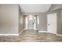 Bright entryway featuring wood-look flooring, gray walls, a white door, and modern recessed lighting at 51 Glasgow Ln, Noblesville, IN 46060