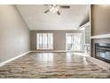 Spacious living room with wood-look floors, a fireplace, and natural light from large windows at 51 Glasgow Ln, Noblesville, IN 46060