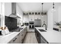Bright, modern kitchen featuring stainless steel appliances, an island with a sink, and contrasting countertops at 525 Fynn Pl, Indianapolis, IN 46202