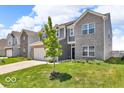 Beautiful two-story home with gray siding and a lush green lawn at 5256 Bramwell Ln, Whitestown, IN 46075