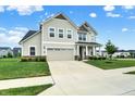 Beautiful home featuring a two-car garage, manicured lawn, and inviting front porch and walkway at 5366 Laurel Crest Run, Noblesville, IN 46062