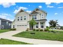 Charming two-story home with green lawn, two-car garage, manicured landscaping, and inviting front porch at 5366 Laurel Crest Run, Noblesville, IN 46062