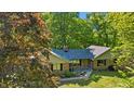 Beautiful brick home surrounded by lush greenery and mature trees in a peaceful setting at 5920 Crooked Creek E Dr, Martinsville, IN 46151