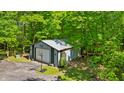 Spacious detached garage with a basketball hoop, nestled among the trees at 5920 Crooked Creek E Dr, Martinsville, IN 46151