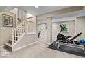 Spacious basement area with workout equipment, staircase and neutral carpet, offering potential for fitness and recreation at 5958 Cape Cod Ct, Indianapolis, IN 46250