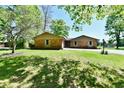 Charming brick ranch home featuring a well-maintained lawn and beautiful shade trees at 5979 E Oak Hl Dr, Plainfield, IN 46168