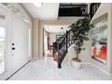 Bright foyer with white marble floors, a grand staircase, and a view into the adjacent dining room at 6374 Timberbluff Cir, Avon, IN 46123