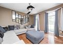 Cozy living room with hardwood floors, a ceiling fan, stylish furniture, and plenty of natural light at 6374 Timberbluff Cir, Avon, IN 46123