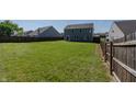 Expansive backyard enclosed by a wooden fence, offering privacy and ample space at 6491 Enclave Blvd, Greenwood, IN 46143