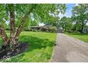 Traditional home with long driveway, lush lawn and mature trees at 665 Spring Hills Dr, Zionsville, IN 46077