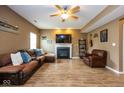 Cozy living room with a fireplace, a large comfortable sectional sofa, and neutral decor at 6683 School Branch Dr, Brownsburg, IN 46112