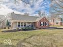 Inviting single-story home with brick and siding, showcasing a well-kept lawn and landscaping at 6839 Chaucer Ct, Indianapolis, IN 46220