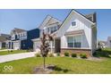 Attractive two-story home with manicured lawn and young tree in a residential neighborhood at 7234 Darley Ln, Indianapolis, IN 46259